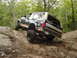 1995 Ford Bronco - Ford Bronco navigates a challenging rocky terrain on an off-road trail.
