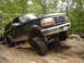 1995 Ford Bronco - A black Ford Bronco navigates a rocky off-road course.