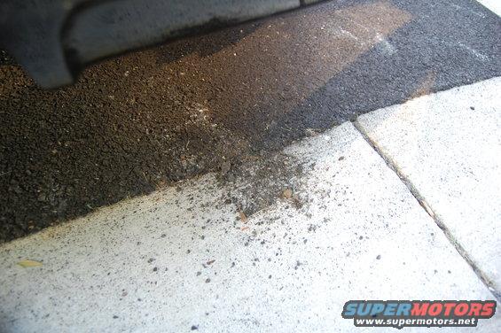 asphalt and concrete curb with dirt debris, Supermotors.net logo visible