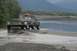 1990 Chevrolet Suburban - A black Jeep Cherokee XJ navigates shallow water while towing a trailer, with another vehicle visible in the distance.