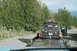 1990 Chevrolet Suburban - A black Jeep Cherokee is loaded onto a flatbed trailer, with a dog standing on the trailer.