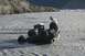 1990 Chevrolet Suburban - Two men attempt to recover an ATV that has become stuck in a rocky riverbed.