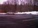 1997 Ford Crown Victoria - A 1997 Ford Crown Victoria is parked in a lot with snowbanks along the treeline.