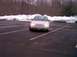1997 Ford Crown Victoria - A tan sedan is parked in a nearly empty parking lot during winter.
