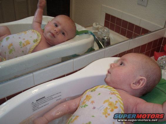 Baby in bathtub reflected in mirror
