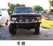 1991 Ford Bronco - Custom front bumper fabrication is visible on this dark-colored SUV.