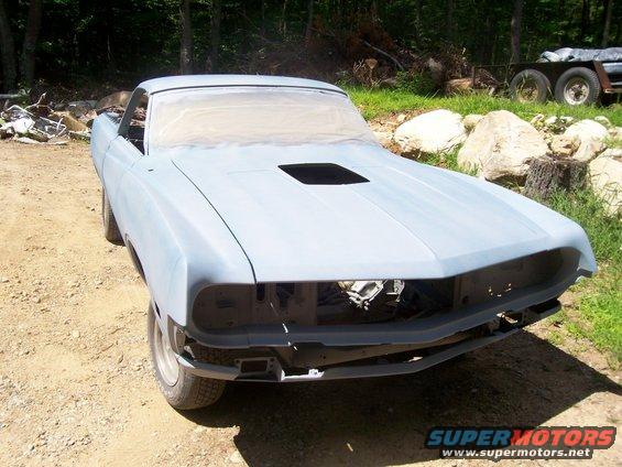 Gray 1970 Ford Ranchero with hood scoop, missing grille, parked outdoors
