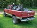 1984 Ford Bronco II - This red pickup truck, likely from the 1980s, is seen from the rear with a spare tire and other items in its bed.