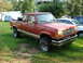 1984 Ford Bronco II - This red pickup truck features off-road tires and a distinctive grille, seen here in a 3/4 front perspective.