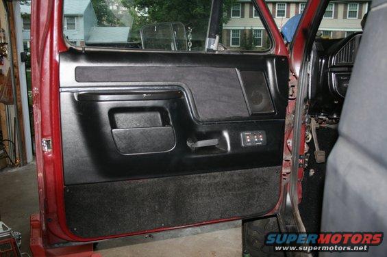 1989 Ford Bronco interior door panel with black fabric and red exterior paint