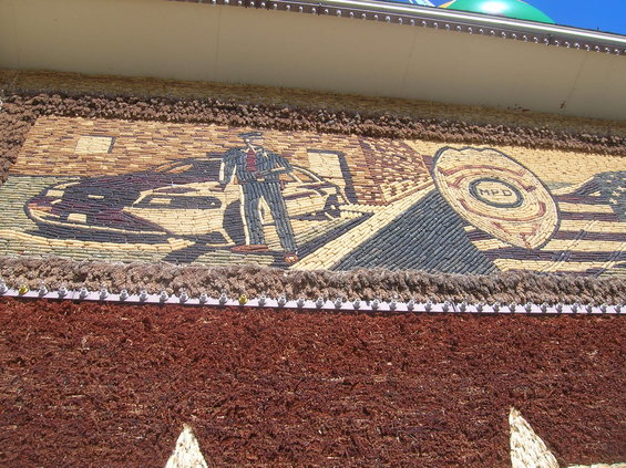 Mural depicting a police officer standing next to a car, with a police badge and American flag
