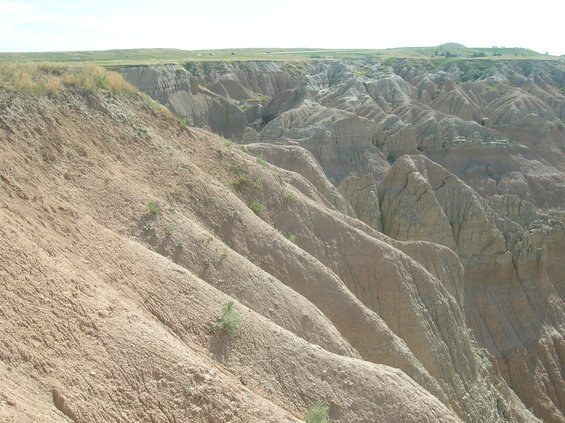 Eroded hills and valleys under a clear sky