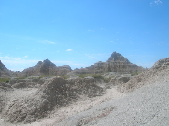 Badlands formations under a clear blue sky