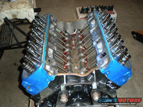 Blue V8 engine block with exposed valves and pushrods