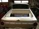 1964 Ford Ranchero - Rear view of a white 1964 Ford Ranchero in a workshop, with the bed open.