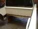 1964 Ford Ranchero - The rear bed and frame of a white pickup truck show significant rust and damage.