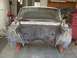1964 Ford Ranchero - The front end of a car is removed, revealing the engine bay and firewall in a garage setting.
