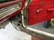 1964 Ford Ranchero - The interior of a 1964 Ford Ranchero shows a red door panel and significant rust on the rocker panel.