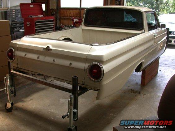 White 1964 Ford Ranchero rear quarter panel and bed on a stand