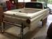 1964 Ford Ranchero - Rear view of a 1964 Ford Ranchero, likely undergoing restoration, supported by a metal stand.