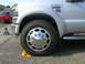 2008 Ford F-450 - Silver 2008 Ford F-450 Super Duty truck front wheel and fender detail, parked on wheel chocks.