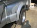 2008 Ford F-450 - Close-up view of the rear fender and dual wheels of a silver 2008 Ford F-450 truck.