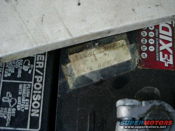 Car battery with handwritten label showing '10-28-01'