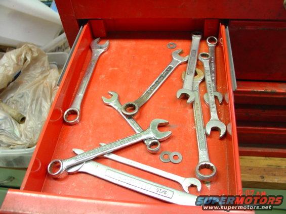 Wrenches of various sizes in a red toolbox drawer. One wrench has '9T/6' visible