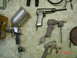 1985 Ford Bronco - A collection of pneumatic tools, including a spray gun and a hammer, are arranged on a tiled surface.