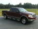 2005 Ford F-150 - This maroon 2005 Ford F-150 pickup truck is shown from the front three-quarter angle.