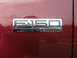2005 Ford F-150 - The F-150 Lariat 5.4 Triton badge is clearly visible on the vehicle's red exterior.