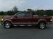 2005 Ford F-150 - This maroon and tan Ford F-150 pickup truck is shown from the side, equipped with a toolbox.