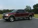 2005 Ford F-150 - This maroon 2005 Ford F-150 pickup truck is shown from a 3/4 front angle.