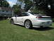 1992 Dodge Stealth - A white sports car is parked on a grassy lawn with houses in the background.