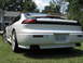 1992 Dodge Stealth - Rear view of a white 1992 Dodge Stealth parked on grass with houses in the background.