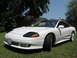 1992 Dodge Stealth - White 1992 Dodge Stealth sports car with black roof and tinted windows sits on a lawn.