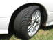 1992 Dodge Stealth - A close-up view of a car's wheel and fender shows a performance tire and a multi-spoke alloy rim.