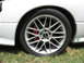 1992 Dodge Stealth - Close-up of a car's front wheel and tire, showing aftermarket modifications.