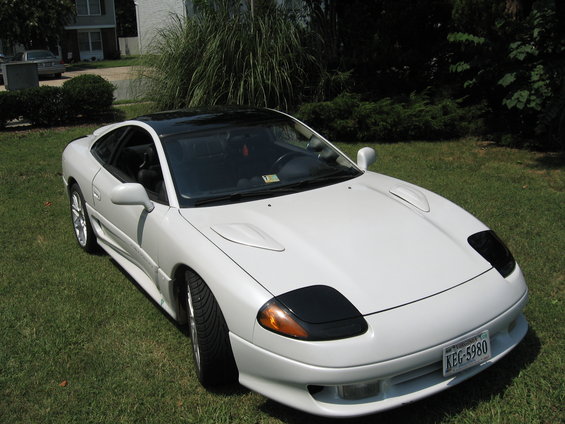 1992 Dodge Stealth parked on grass, front 3/4 view. Black roof, white body, black headlight covers