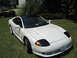 1992 Dodge Stealth - White 1992 Dodge Stealth with a black roof and black headlight covers sits on a grassy lawn.