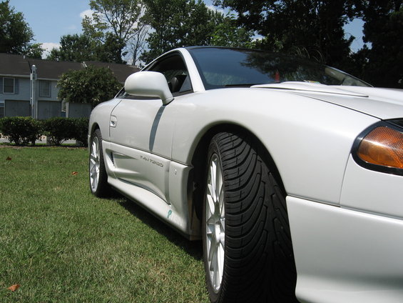 White sports car side view with "TWIN TURBO" text visible on rocker panel