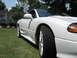 1992 Dodge Stealth - Side profile of a white sports car, "TWIN TURBO" badging on the lower body panel.