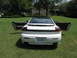 1992 Dodge Stealth - Rear view of a white 1992 Dodge Stealth with both doors open, parked on a grassy lawn.