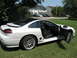 1992 Dodge Stealth - A white 1992 Dodge Stealth is parked on a grassy lawn with its doors open, showing the interior.
