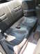 1992 Dodge Stealth - Interior view of car's rear seating area, including seats, seatbelts, and floor carpeting.