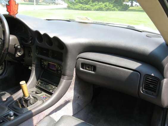 Interior shot of a 1992 Dodge Stealth showing the dashboard, center console with shifter, and part of the steering wheel