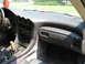 1992 Dodge Stealth - The dashboard and center console of a 1992 Dodge Stealth are visible, with a red leaf air freshener hanging from the rearview mirror.