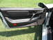1992 Dodge Stealth - Interior view of a car's driver side door panel, revealing black trim and controls.