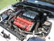 1992 Dodge Stealth - Engine bay of a white car, showing the V6 engine with red valve covers and aftermarket intake.