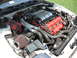 1992 Dodge Stealth - Engine bay of a 1992 Dodge Stealth RT/TT, red valve covers and an aftermarket air intake system.